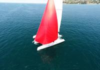 red spinnaker-gennaker white yacht sailing at blue sea